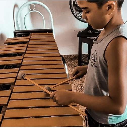 Menino tocando marimba na Oficina de Percussão Sinfônica